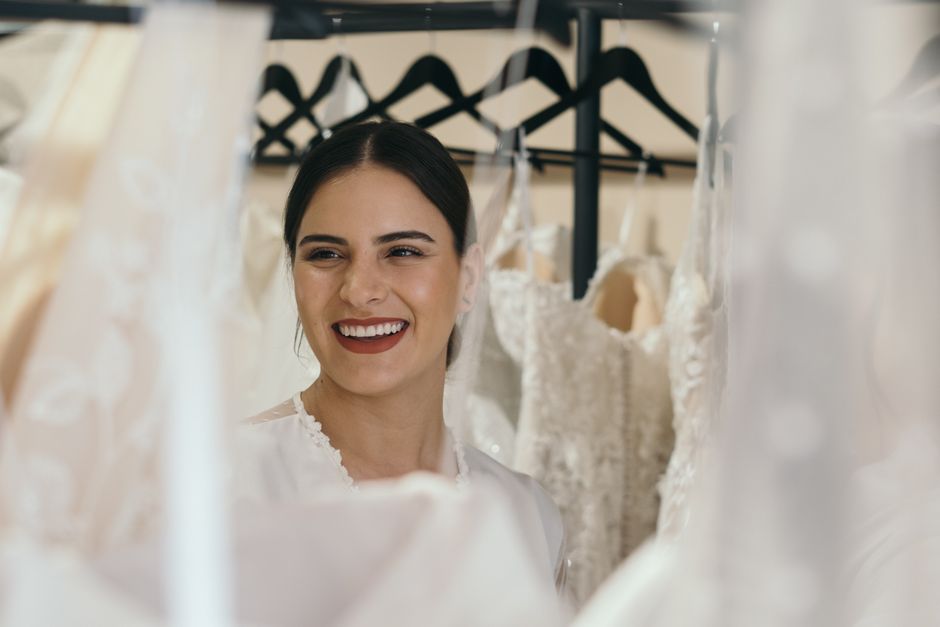 Orange County wedding gowns bride trying on luxury dress in Southern California bridal salon