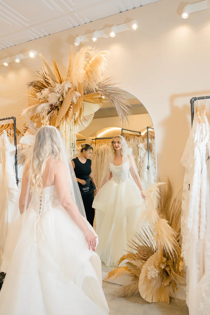 plus size bride trying on bridal gown