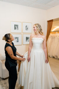 plus size bride trying on wedding dress